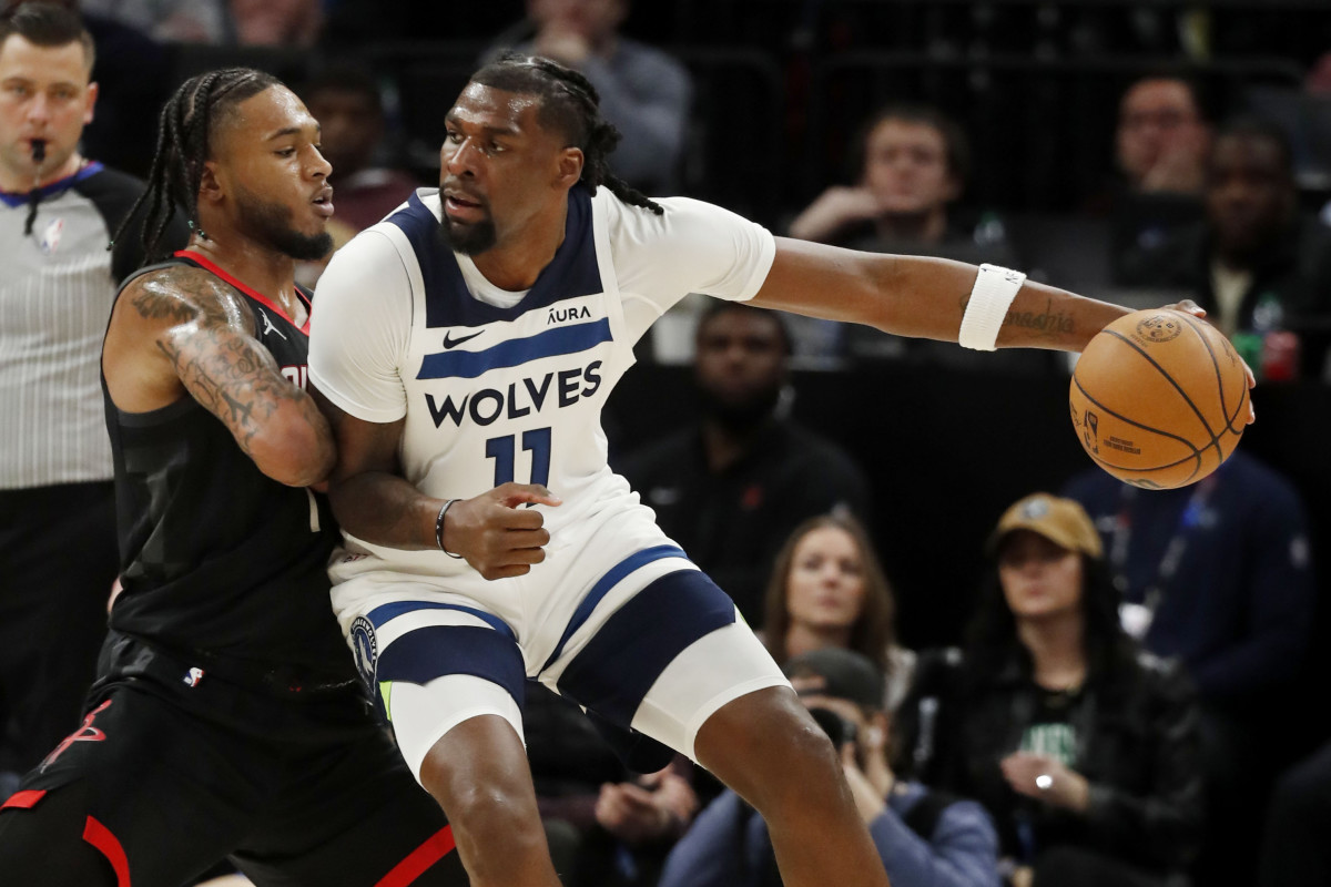 Feb 4, 2024; Minneapolis, Minnesota, USA; Minnesota Timberwolves center Naz Reid (11) drives to the basket against Houston Rockets guard Cam Whitmore (7) in the fourth quarter at Target Center.